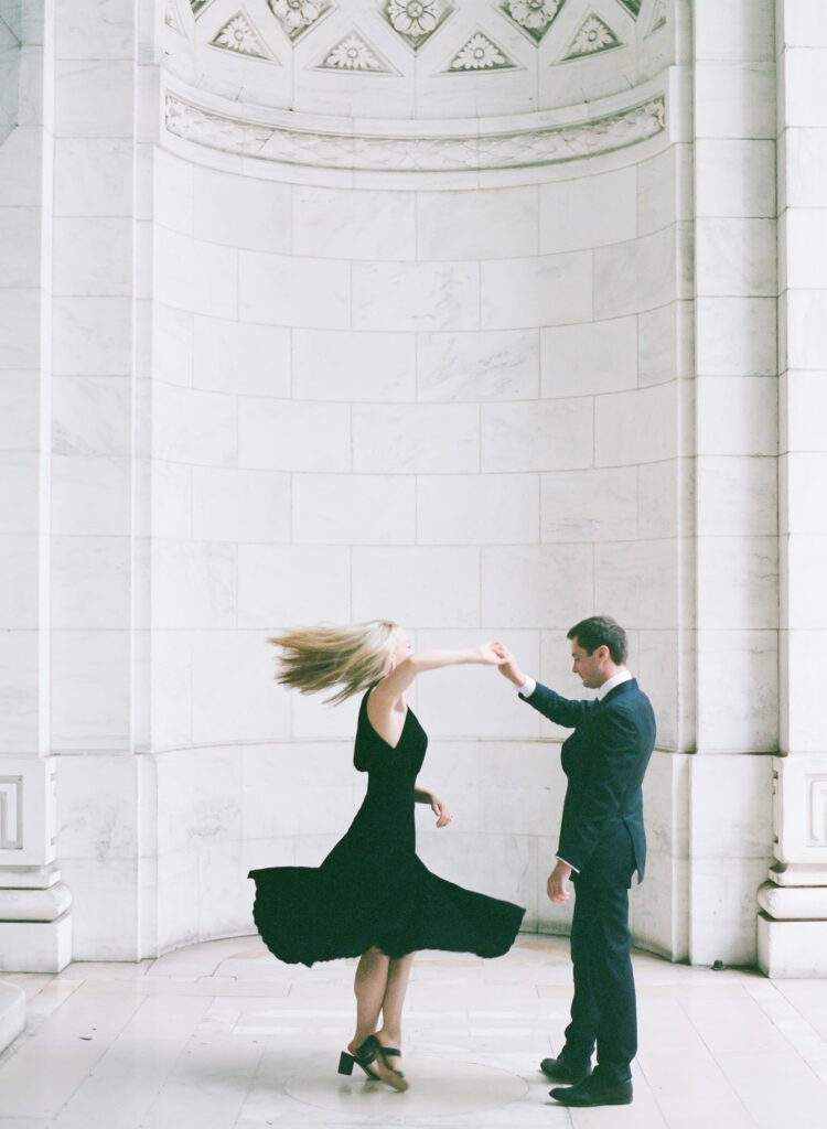 Spinning around during an engagement session at New York Public Library, New York.