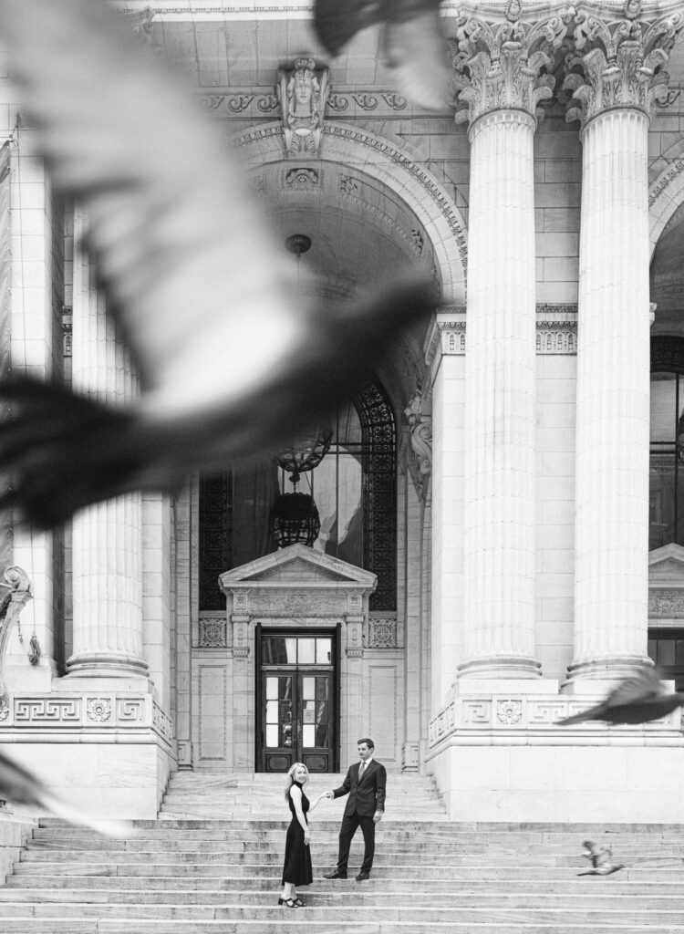 Pigeons flying during an engagement session at New York Public Library, New York.