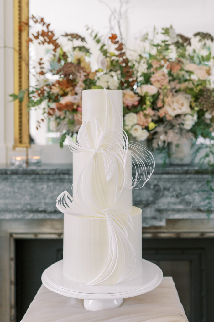Minimalistic and sophisticated white wedding cake, see more beautiful wedding cakes of 2023 on my blog.